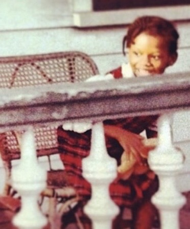 Makeda Coleman as a child on a front porch